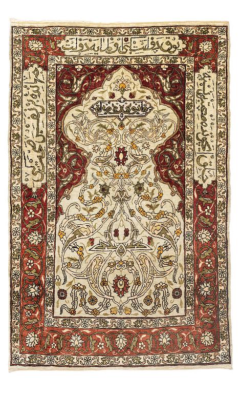 A silk and metal Hereke rug, c. 80 x 51 cm.