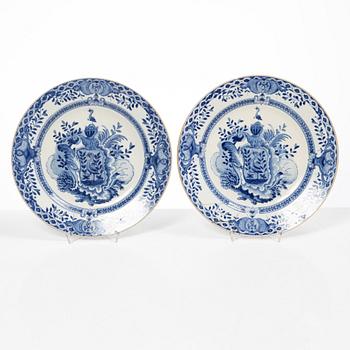 A pair of armorial dinner plates, soft paste, Qing dynasty, 18th century.