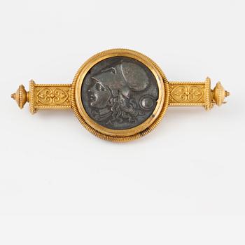 BROSCH, mynt infattat i låghaltigt guld.