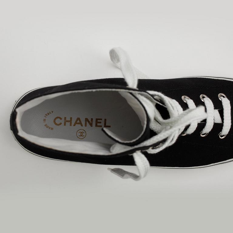 CHANEL, a pair of black canvas sneakers.