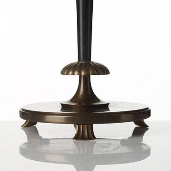 A 1920's patinated metal, lacquered wood, etched och cut glass table lamp, unknown designer, 1920's.