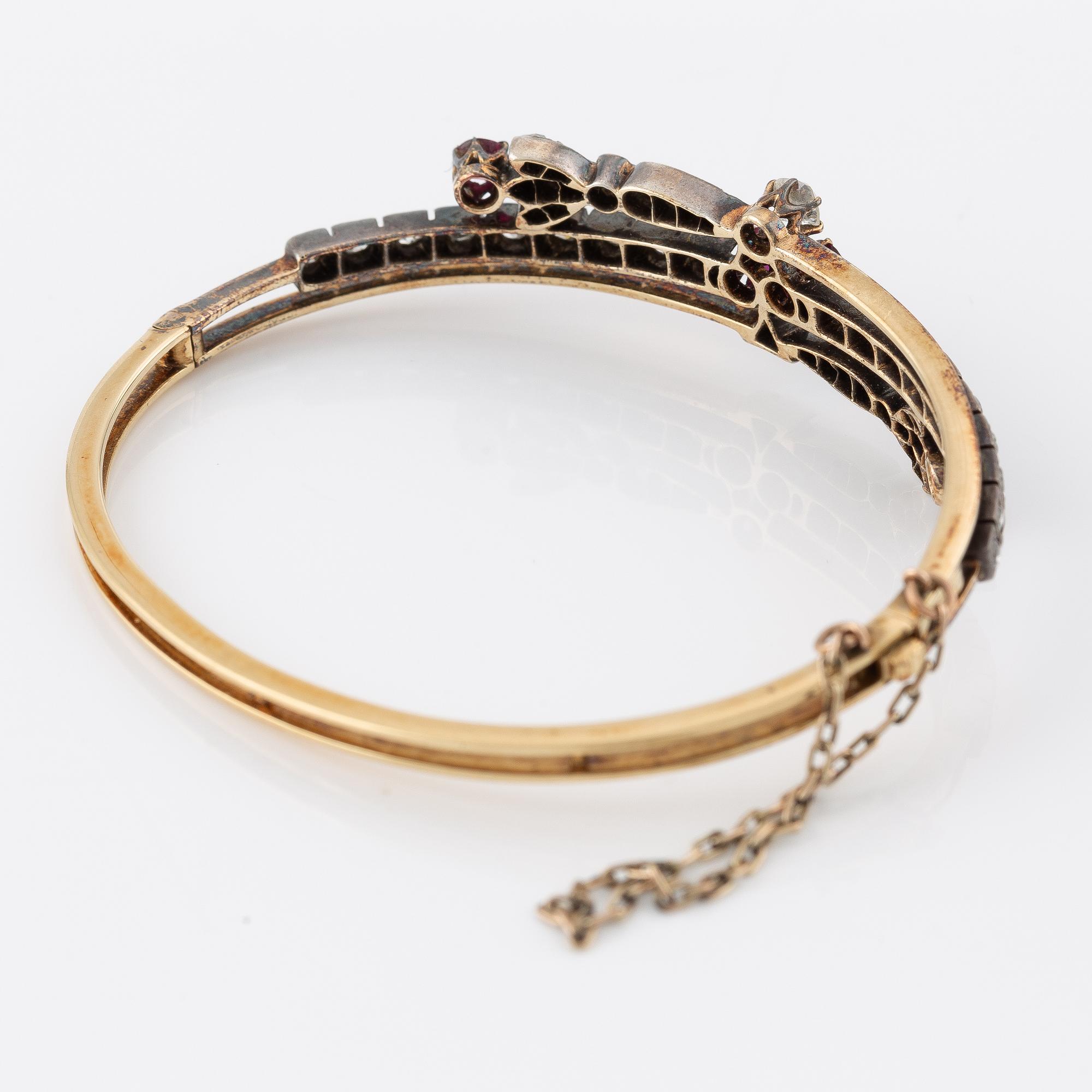 Arm ring in gold and silver set with old-cut and rose-cut diamonds and rubies.