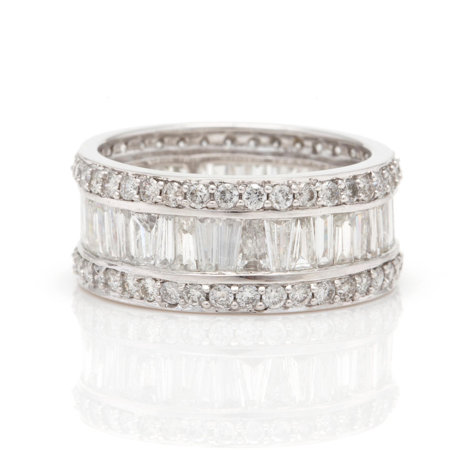 A ring with round, brilliant-cut and tapered, baguette-cut diamonds.
