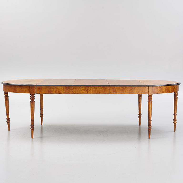A birch veneered dining table, second half of the 19th Century.