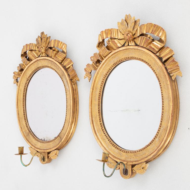 A pair of one-light Gustavian-style giltwood girandole mirrors, late 18th c /resp circa 1900.