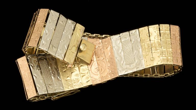 A tricoloured gold bracelet with flower motifs.