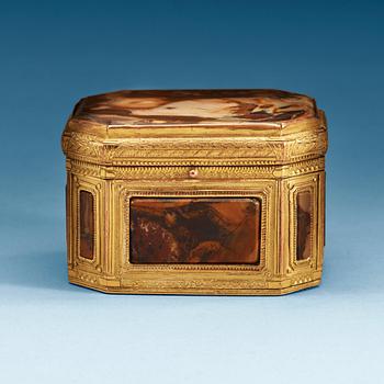 881. A gilt-brass, stone and glass box with double-folded lid with erotic scene. Louis XVI.