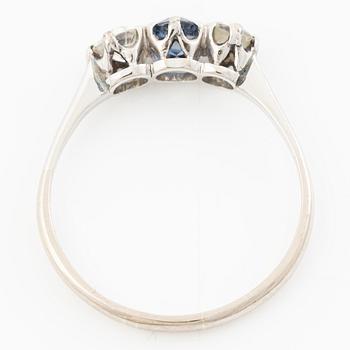 18K gold ring with two old-cut diamonds and a blue stone.