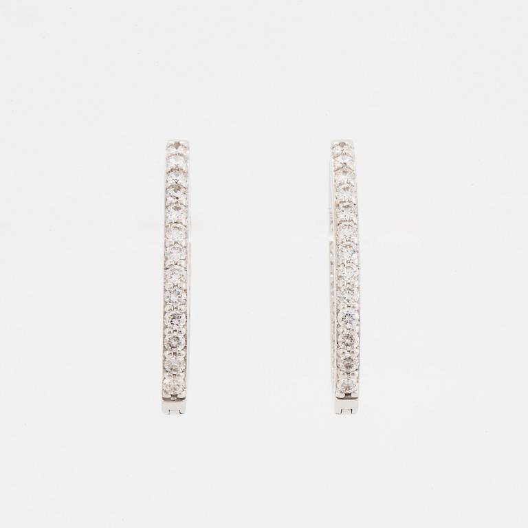 Brilliant-cut diamond hoop earrings.