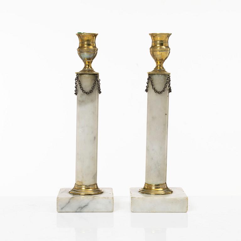 A pair of Gustavian brass and marble candlesticks, circa 1800.