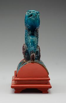 A turquoise and purple glazed roof top tile in the shape of a fish, Ming dynasty.