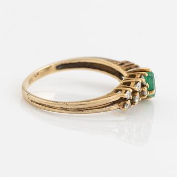 18K gold, navette shaped emerald and brilliant cut diamond ring.