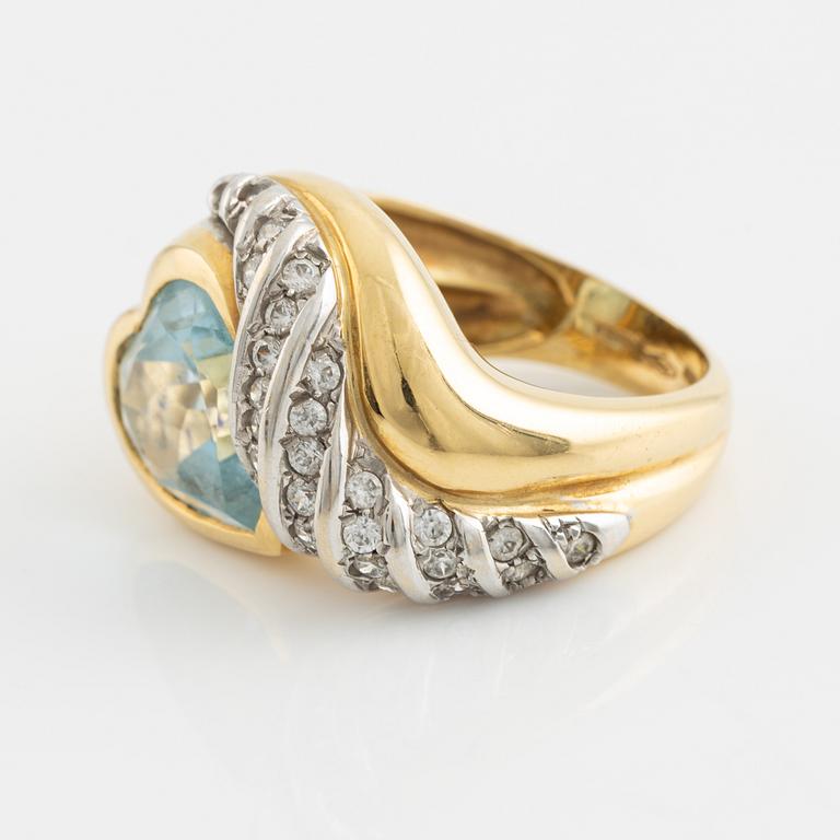 18K gold and heart shaped blue topaz and white stones.