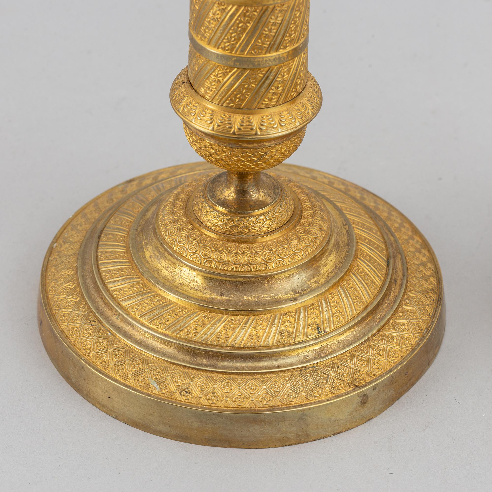 An early 19th Century pair of bronze empire candle sticks.