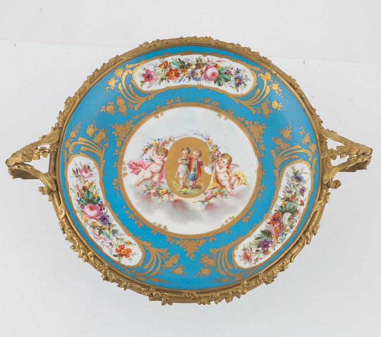 A French porcelain and brass centrepiece, second half of the 19th Century.