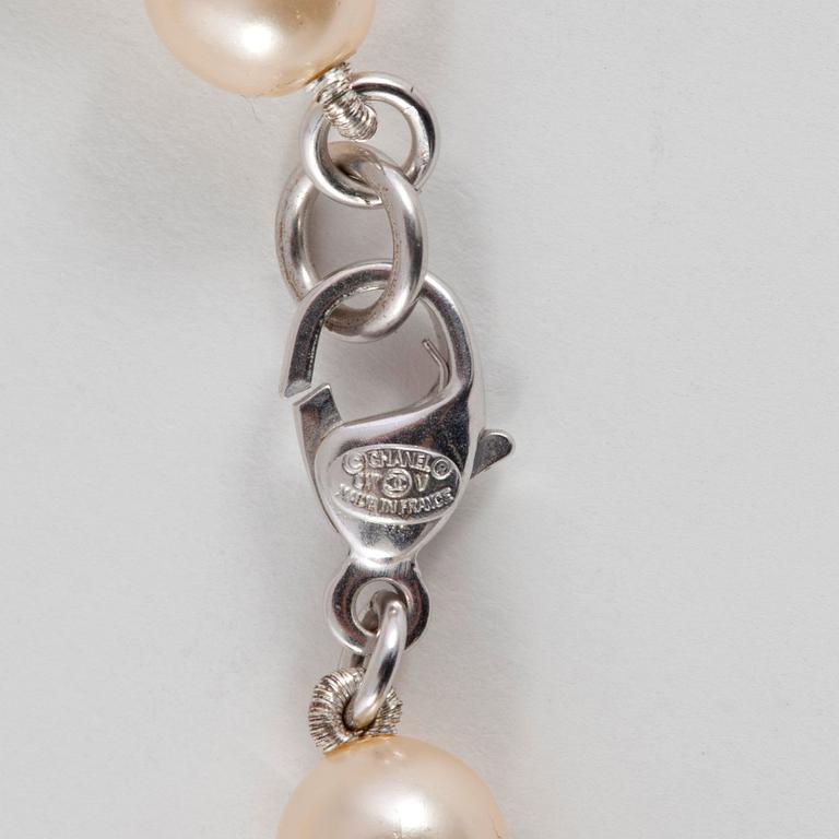 CHANEL, a decorative pearl necklace.