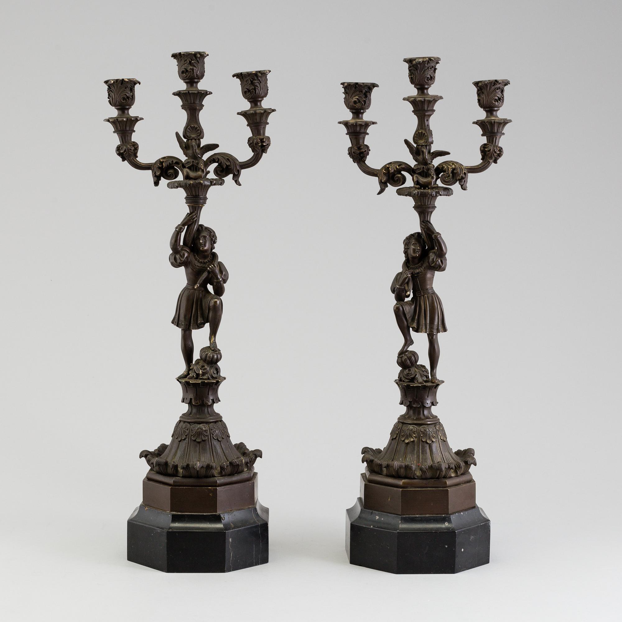 A pair of late 19th century patinated brass candelabra.