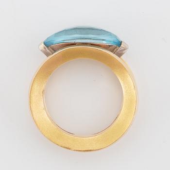 18K gold and navette shaped blue topaz.