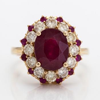 A 14K gold cluster ring, with rubies and brilliant-cut diamonds.