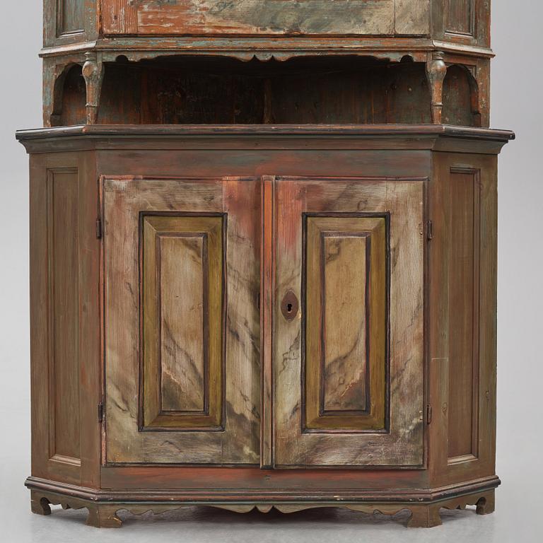 A Swedish polychrome-painted corner cabinet attributed to J. Bäckström (1773-1837).