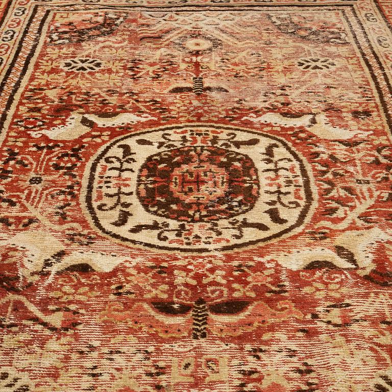 A CARPET, an antique Khotan, ca 296,5 x 181 cm.