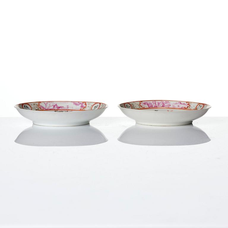 A pair of famille rose 'figural' tea cups with saucers, Qing dynasty, Qianlong (1736-95).