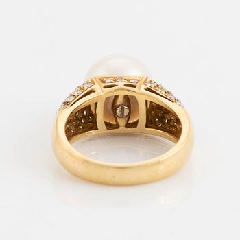 An 18K gold ring set with a cultured South Sea pearl and round brilliant-cut diamonds.