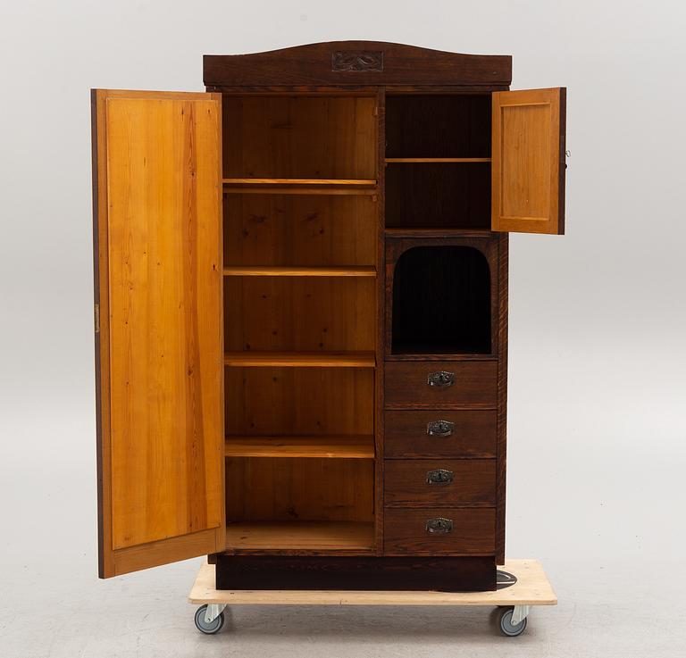 An early 20th century oak cabinet with drawers.