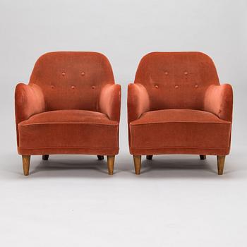 A pair of mid-20th-century armchairs.