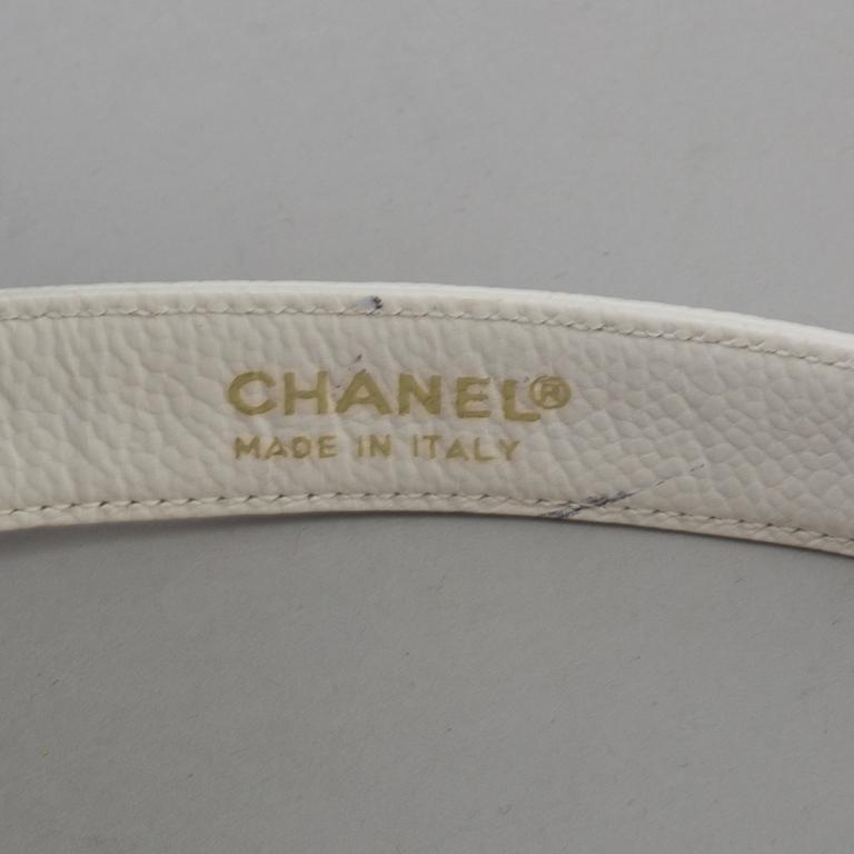 White caviar leather belt by Chanel.