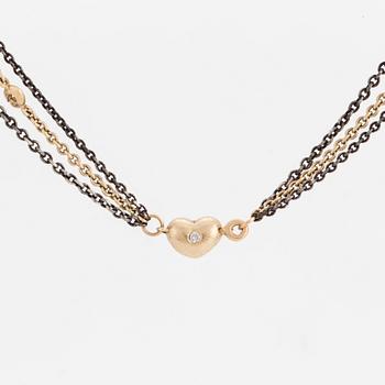 A necklace by Ole Lynggaard, the clasp decorated with a diamond.