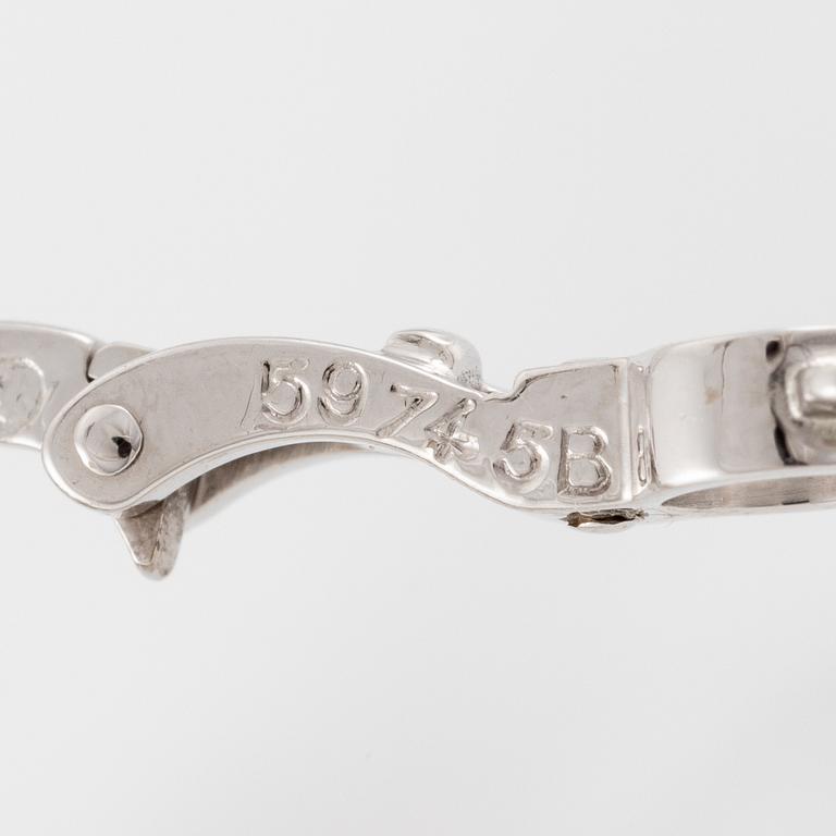 Cartier a pair of earrings platinum set with drop-shaped and round brilliant-cut diamonds.