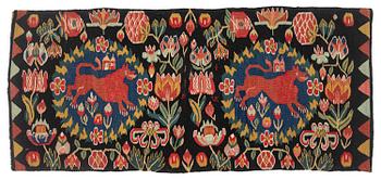 329. A cushion, 'Red Lion' (Rött Lejon), tapestry weave, c. 102 x 46cm, southwestern Scania, first part of the 19th century.