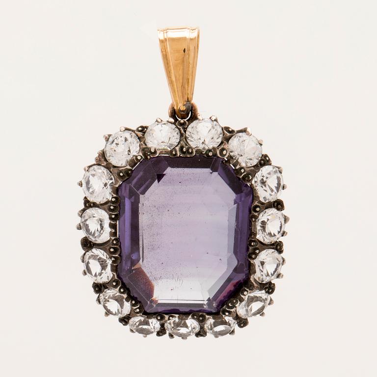 Pendant in low-grade gold and silver set with a synthetic color-changing purple sapphire, and synthetic stones.
