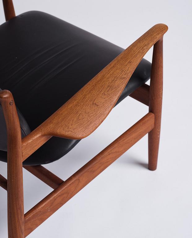 Finn Juhl, a teak and black leather 'model 136' easy chair, France & Daverkosen, Denmark 1950-60s.