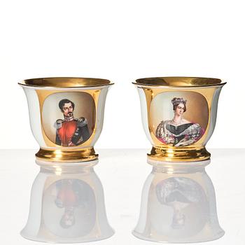A pair of late Empire Chocolate cups with stands, 19th Century, one signed by Wilhelm Heinemann, Stockholm.