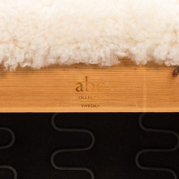 A contemporary sheepskin upholstered lounge chair, ABC collection.