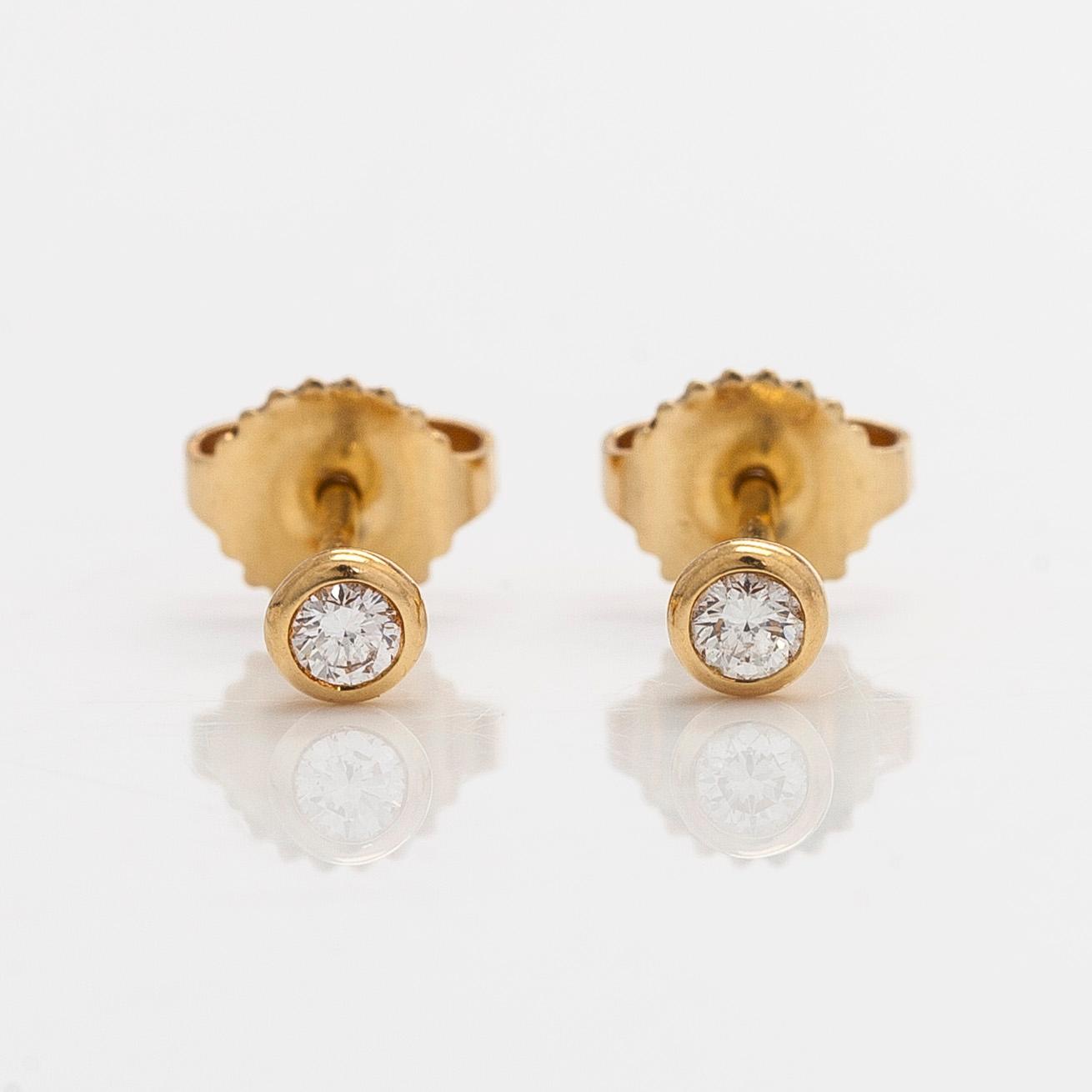 Tiffany & Co, Elsa Peretti, a pair of 18K gold 'Diamonds by The Yard' earrings with brilliant-cut diamonds.