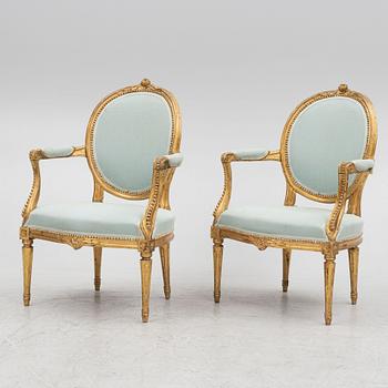 A sofa and a pair of chairs, Louis XVI style, circa 1900.