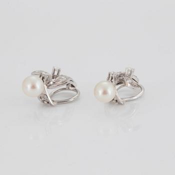 A pair of earrings set with eight- and round brilliant-cut diamonds and cultured pearls.