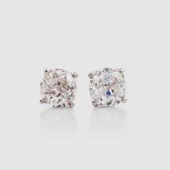1336. A pair of old-cut diamond solitaire earrings. Total carat weight circa 3.26 cts. Quality circa K-L/VS-SI.