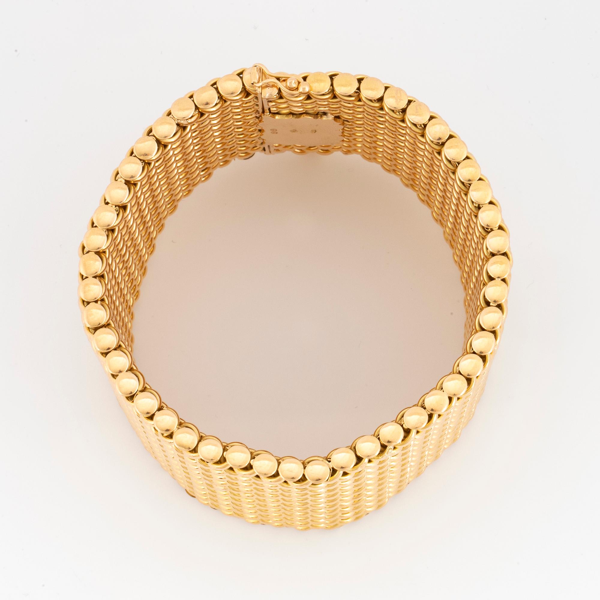 An 18K gold bracelet.