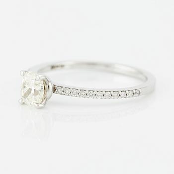 Ring with cushion-cut diamond.