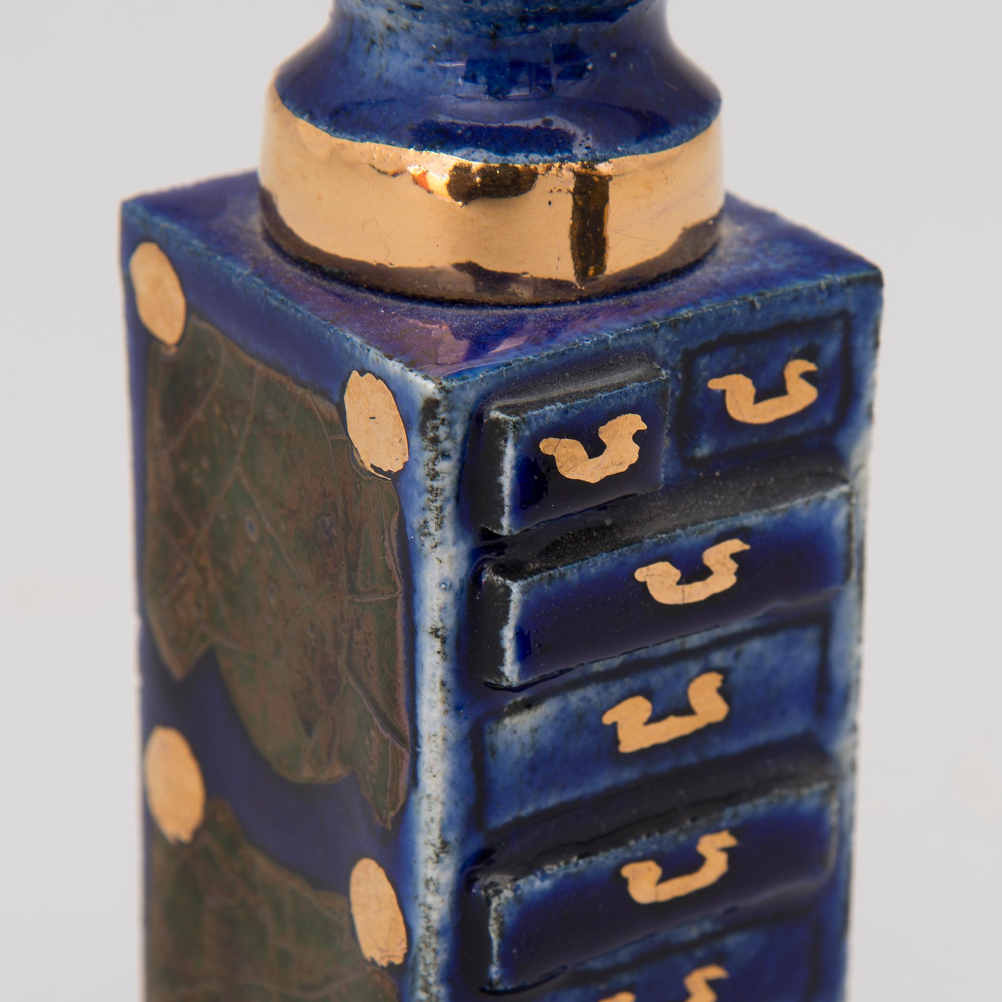 A pair of ceramic candlesticks signed Kaipiainen.