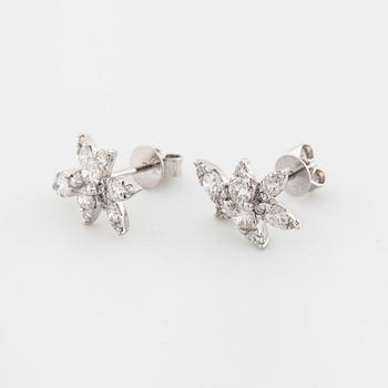 A pair of brilliant cut diamond earrings.