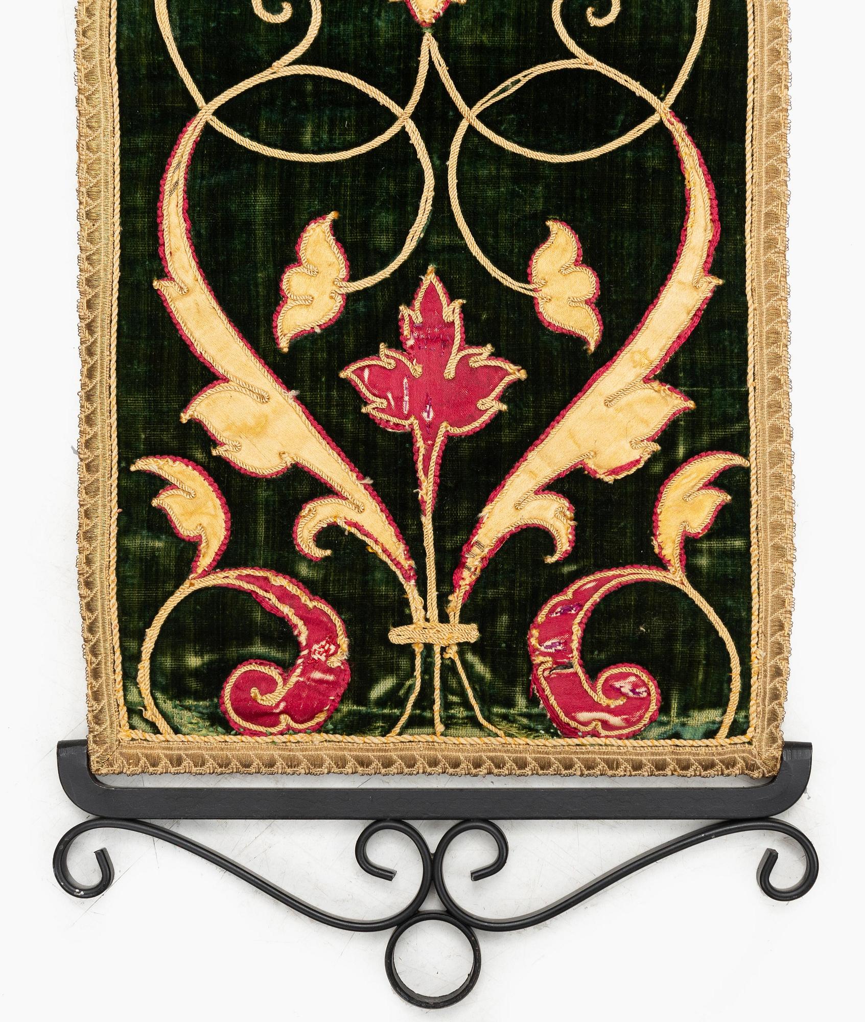 A 17th century Spanish embroidered velvet panel, c. 77 x 18.5 cm.