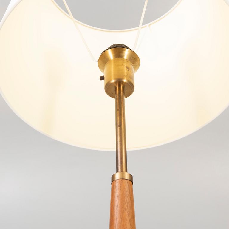 A 1960s brass and teak floor lamp.