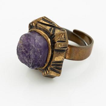 Pentti Sarpaneva, A bracelet, a pair of earrings, a ring, and a pendant, bronze with amethyst, Finland 1960s.