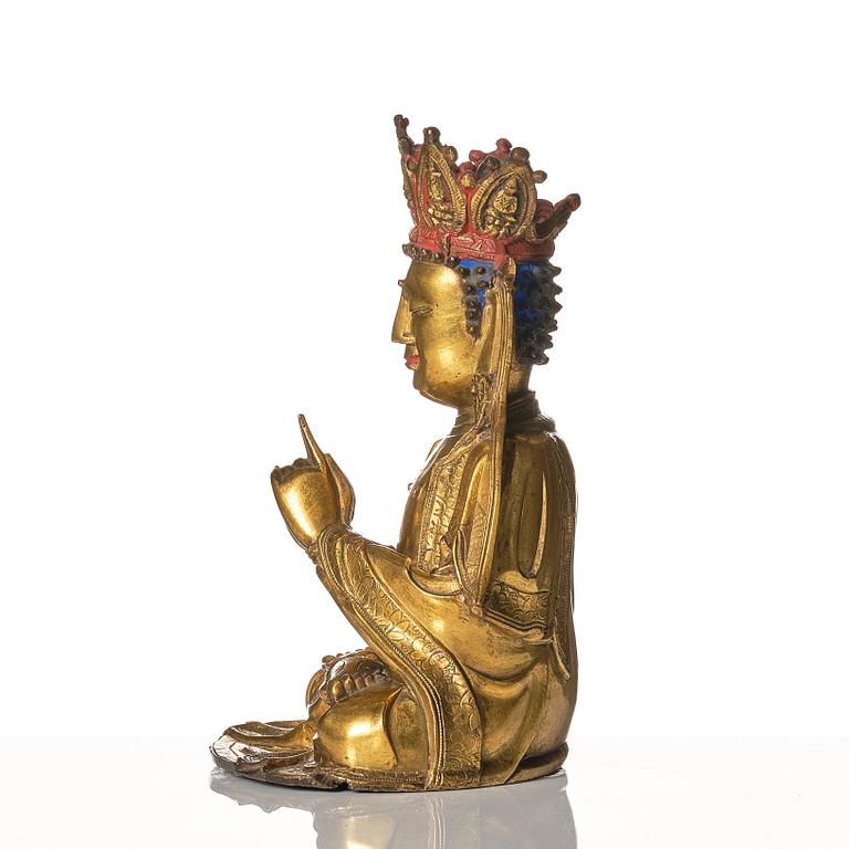 A gilt-bronze figure of Vairochana, Ming dynasty (1638-1644).