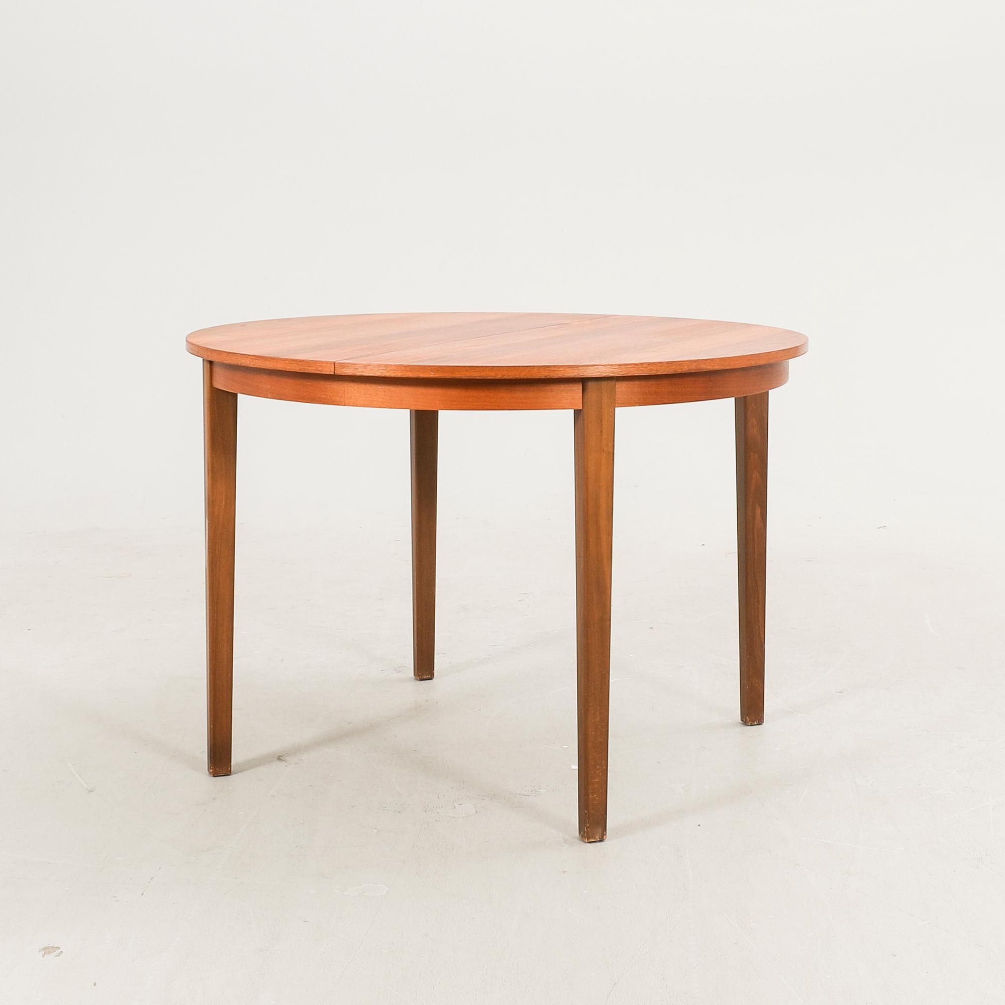 A 1960s walnut dining table.